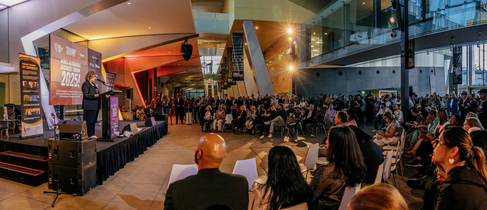 Audience listens to presenter speaking at the Welcome Reception of the 2025 World Indigenous Business Forum in Melbourne