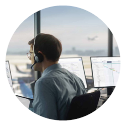 A man sits in the observation tower of an airport