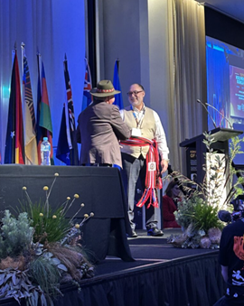 Hans P Bokelund receiving the Red River Métis sash
