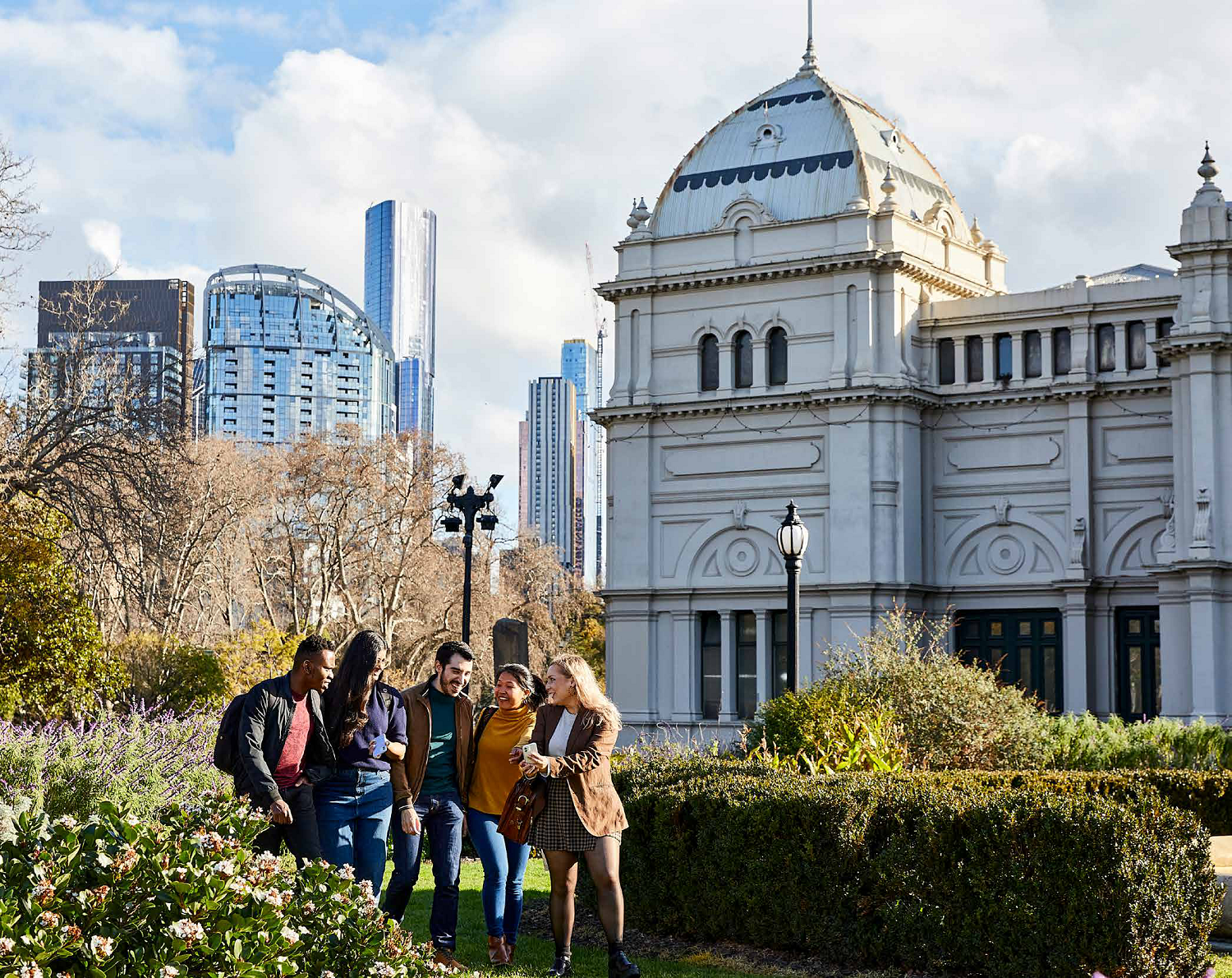 University students gather in a garden outside the Melbourne Exhibition Gardens