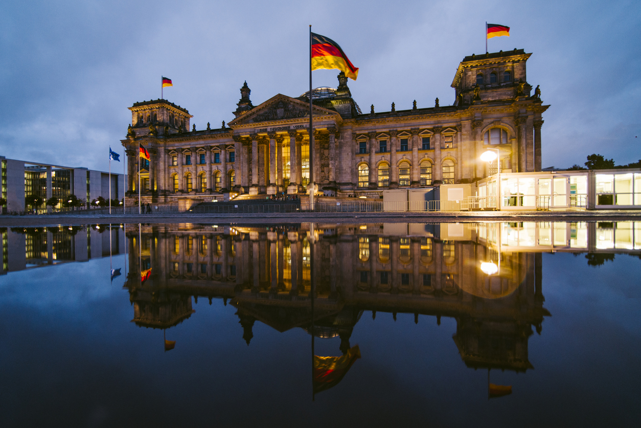 The Reichstag building in Berlin, Germany, and its reflection at night