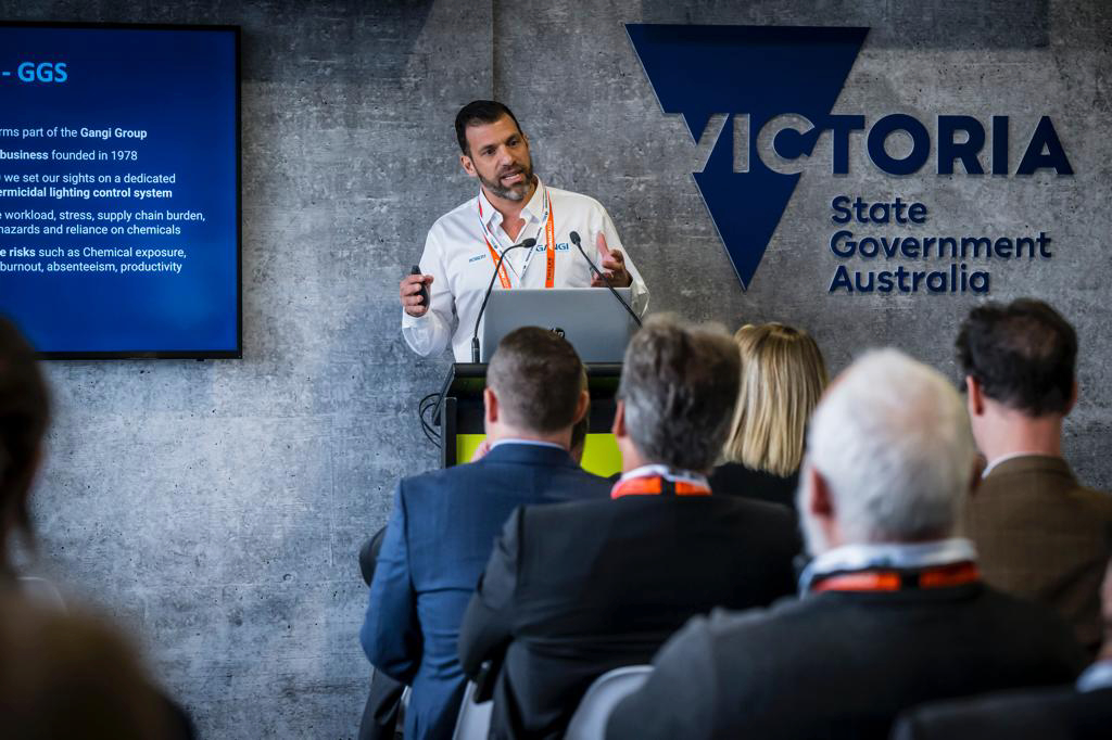 A Lindo spokesperson stands at a podium and presents to an audience 